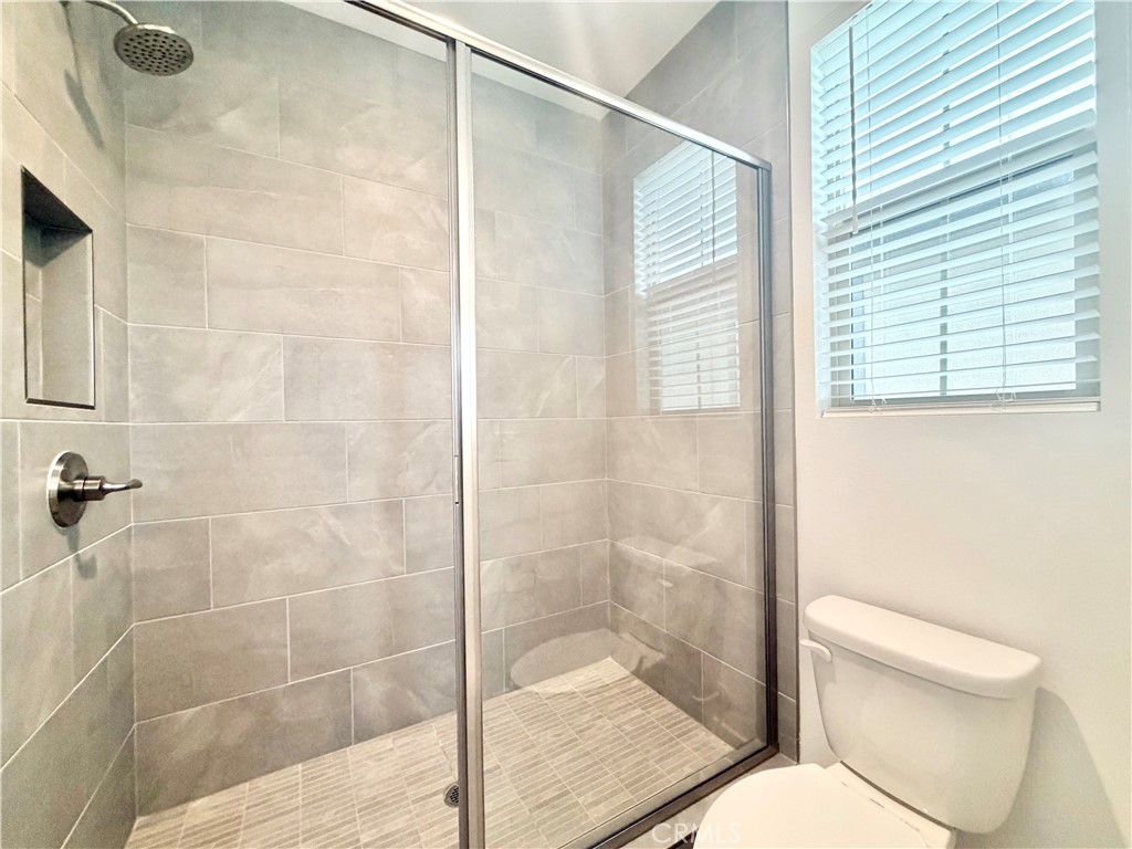 26893 Rubicon Road Menifee, CA 92586 - Photo 27 of 32 a bathroom with a toilet and shower
