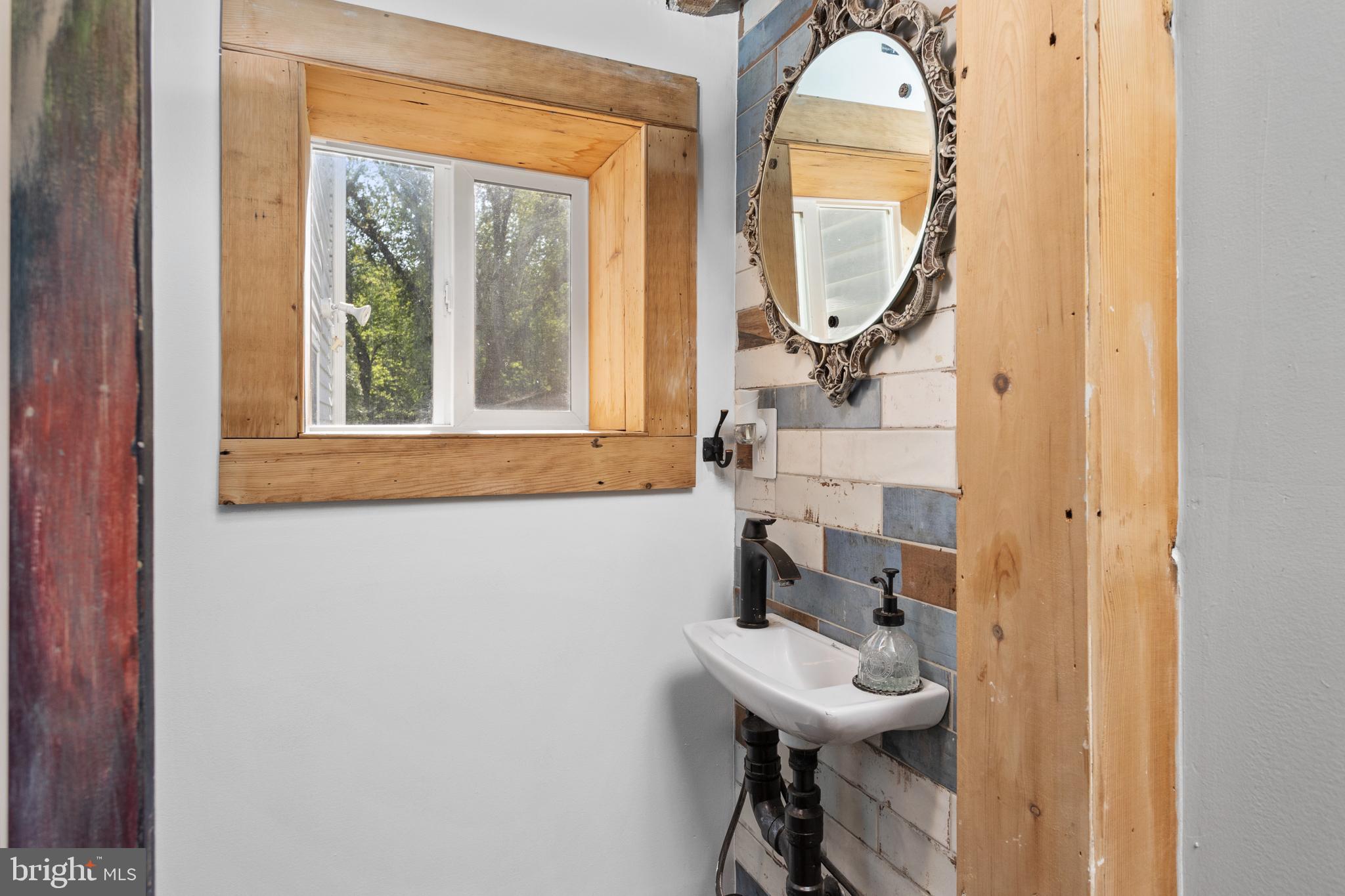 942 Province Line Road Allentown, NJ 08501 - Photo 19 of 50 a bathroom with a sink a mirror and a window