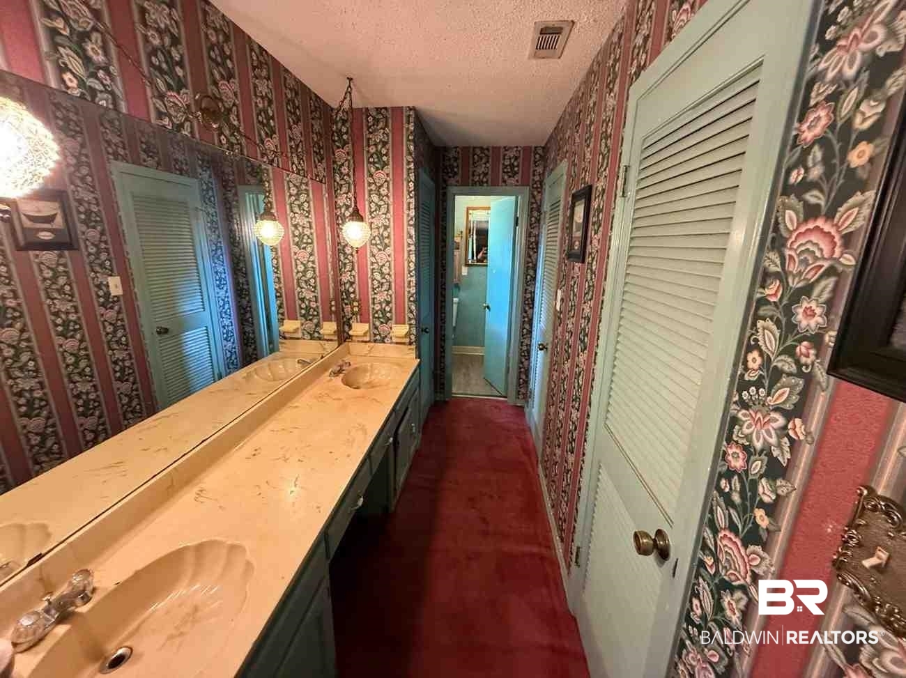 3721 Robertson Court Mobile, AL 36693 - Photo 21 of 22 Full bath with wallpapered walls, a closet, double vanity, and a textured ceiling