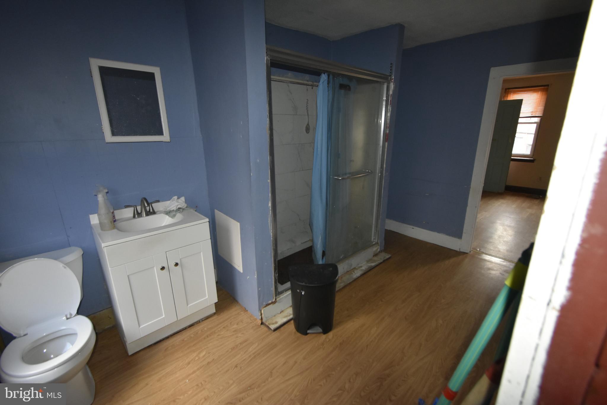 1653 Cadwallader Street Philadelphia, PA 19122 - Photo 21 of 34 a bathroom with a toilet sink and a mirror