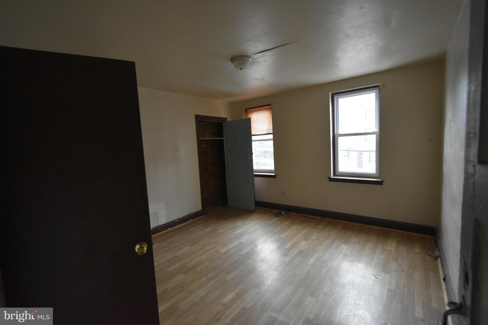 1653 Cadwallader Street Philadelphia, PA 19122 - Photo 22 of 34 a view of an empty room with wooden floor and a window