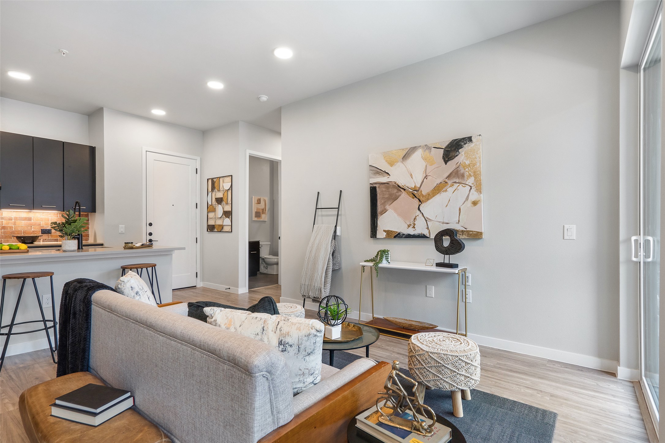 4510 Terry-O Lane, Unit 341 Austin, TX 78745 - Photo 15 of 40 The property features an open-concept living area with light-toned flooring, recessed lighting, and a sliding glass door providing natural light