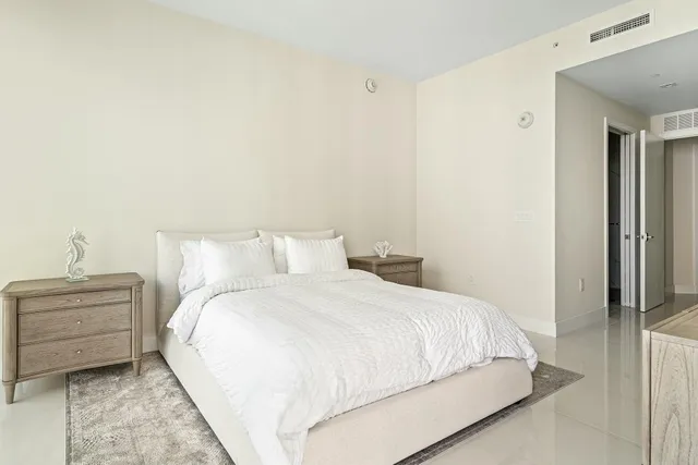 a bedroom with a bed and a night stand