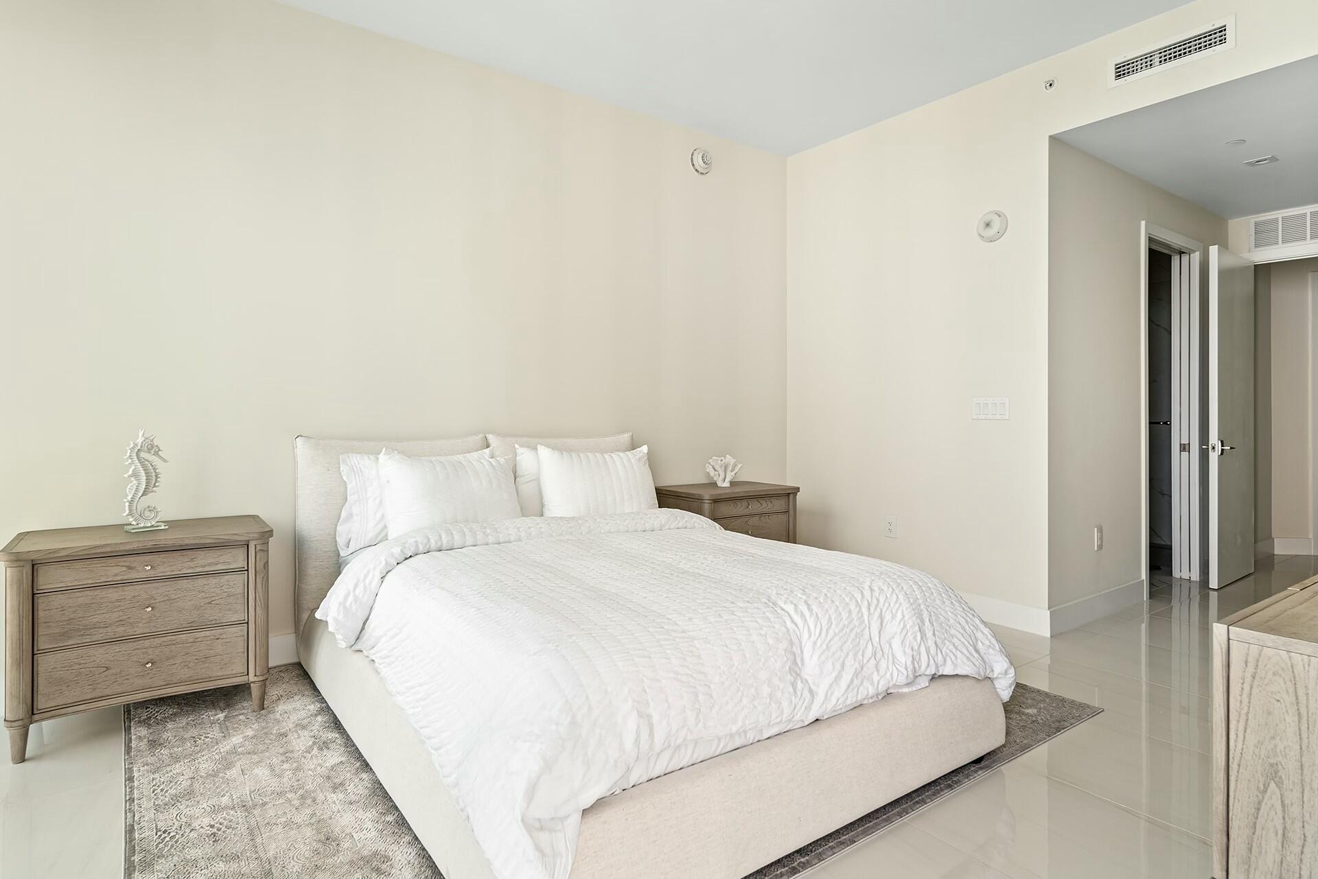 3100 North Ocean Drive, Unit H1409 Singer Island, FL 33404 - Photo 11 of 31 a bedroom with a bed and a night stand