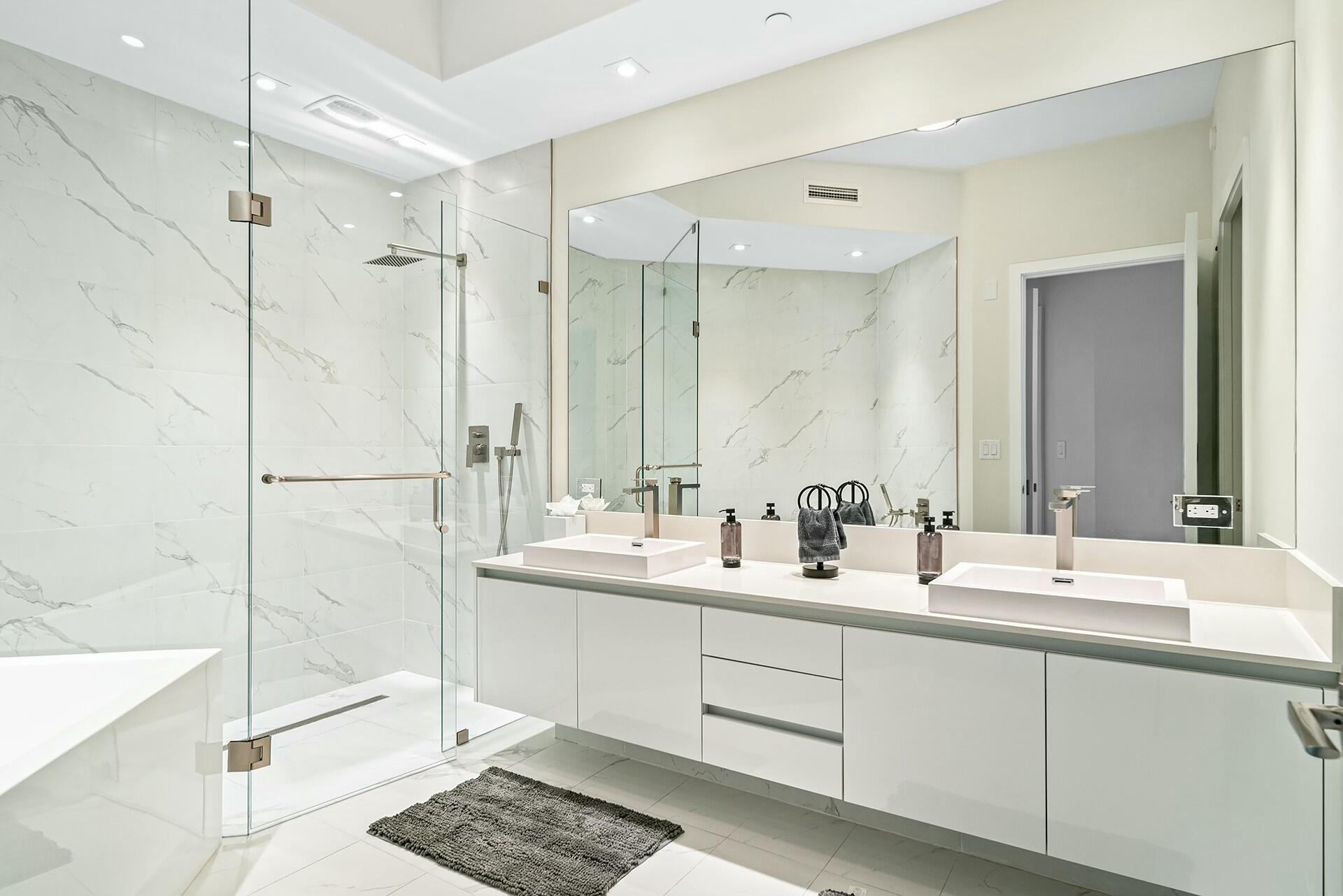 3100 North Ocean Drive, Unit H1409 Singer Island, FL 33404 - Photo 21 of 31 a bathroom with a double vanity sink mirror and double