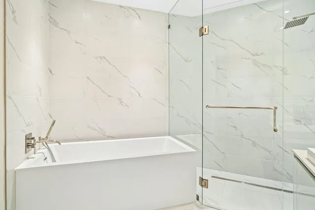 a bathroom with a bathtub and shower