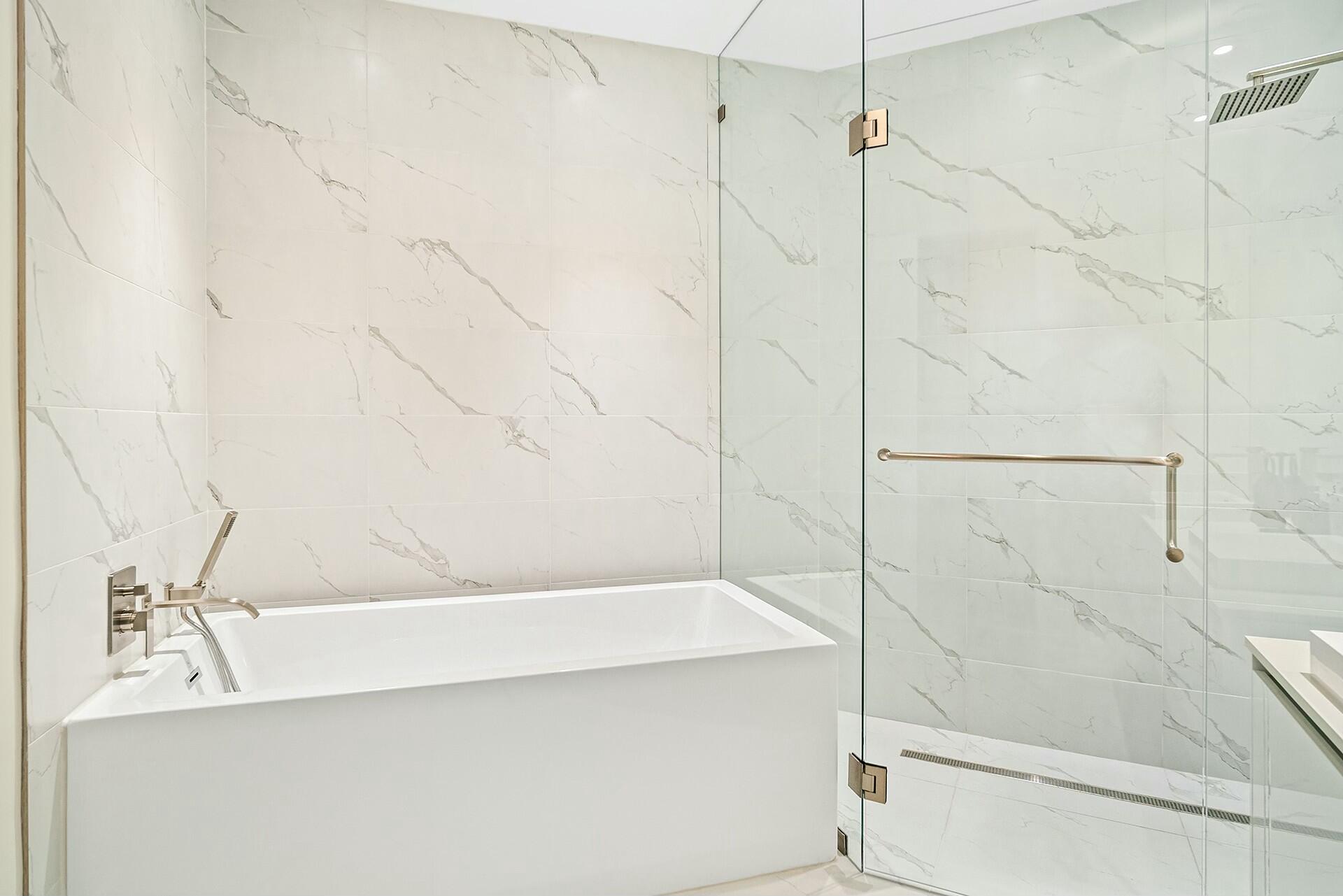 3100 North Ocean Drive, Unit H1409 Singer Island, FL 33404 - Photo 24 of 31 a bathroom with a bathtub and shower