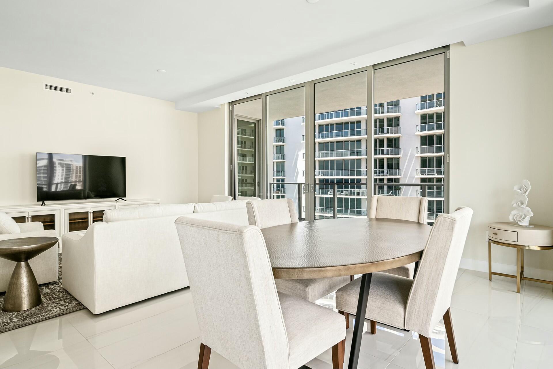 3100 North Ocean Drive, Unit H1409 Singer Island, FL 33404 - Photo 3 of 31 a view of a dining room with furniture and a flat screen tv