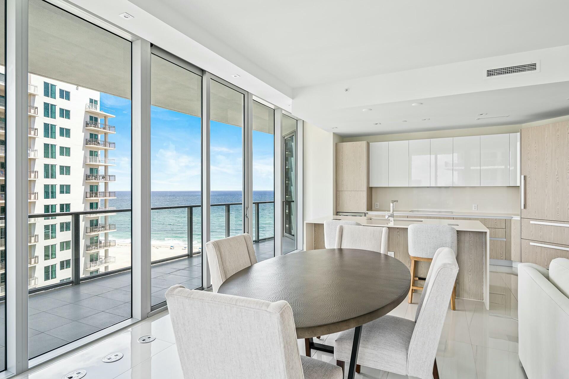 3100 North Ocean Drive, Unit H1409 Singer Island, FL 33404 - Photo 4 of 31 a dining room with furniture and a floor to ceiling window