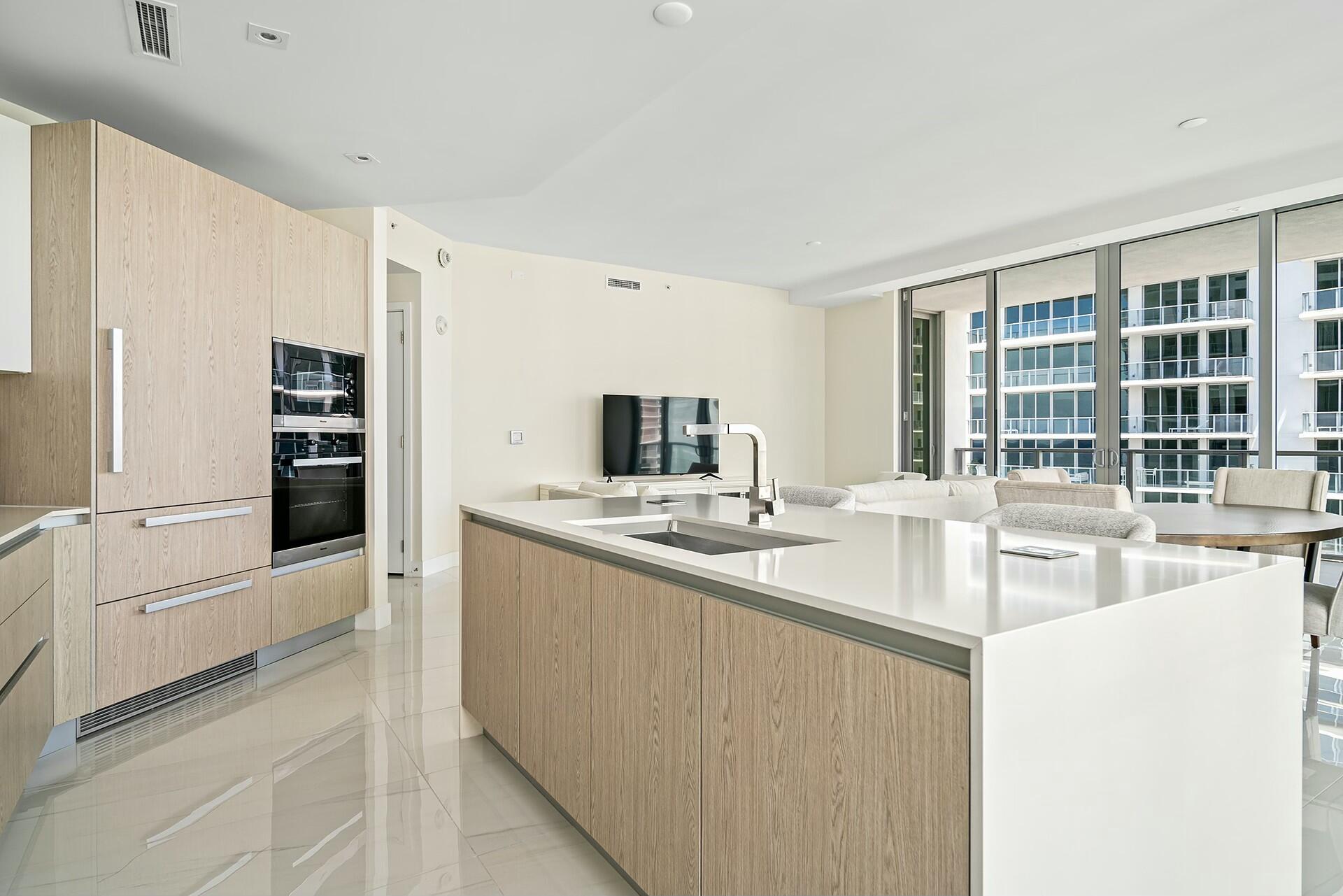 3100 North Ocean Drive, Unit H1409 Singer Island, FL 33404 - Photo 7 of 31 a kitchen with stainless steel appliances granite countertop a sink and dishwasher a refrigerator a oven with white cabinets