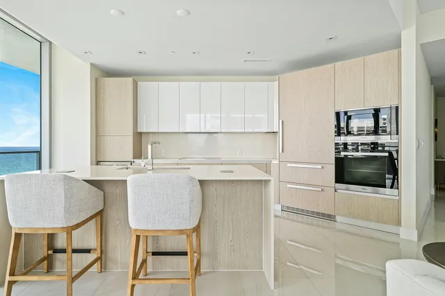 a kitchen with a table chairs refrigerator and cabinets