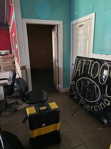 a room with water heater and wooden cabinets