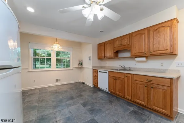 a kitchen with granite countertop a stove sink and microwave