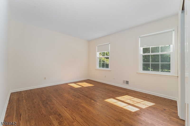 478 Charlestown Road Hampton, NJ 08827 - Photo 16 of 44 an empty room with wooden floor and windows
