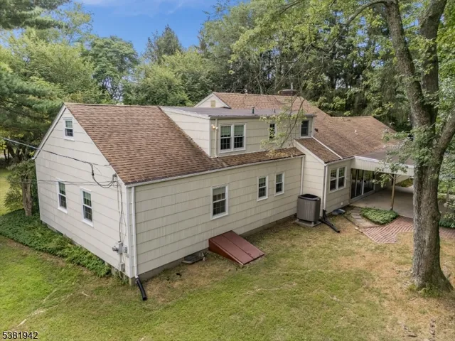 an aerial view of a house with a yard and balcony