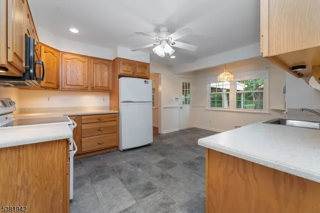 a kitchen with furniture a refrigerator and a sink