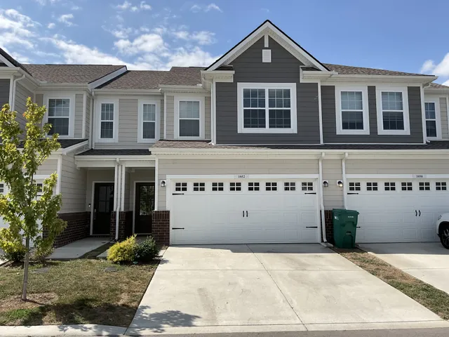 a front view of a building with a garden