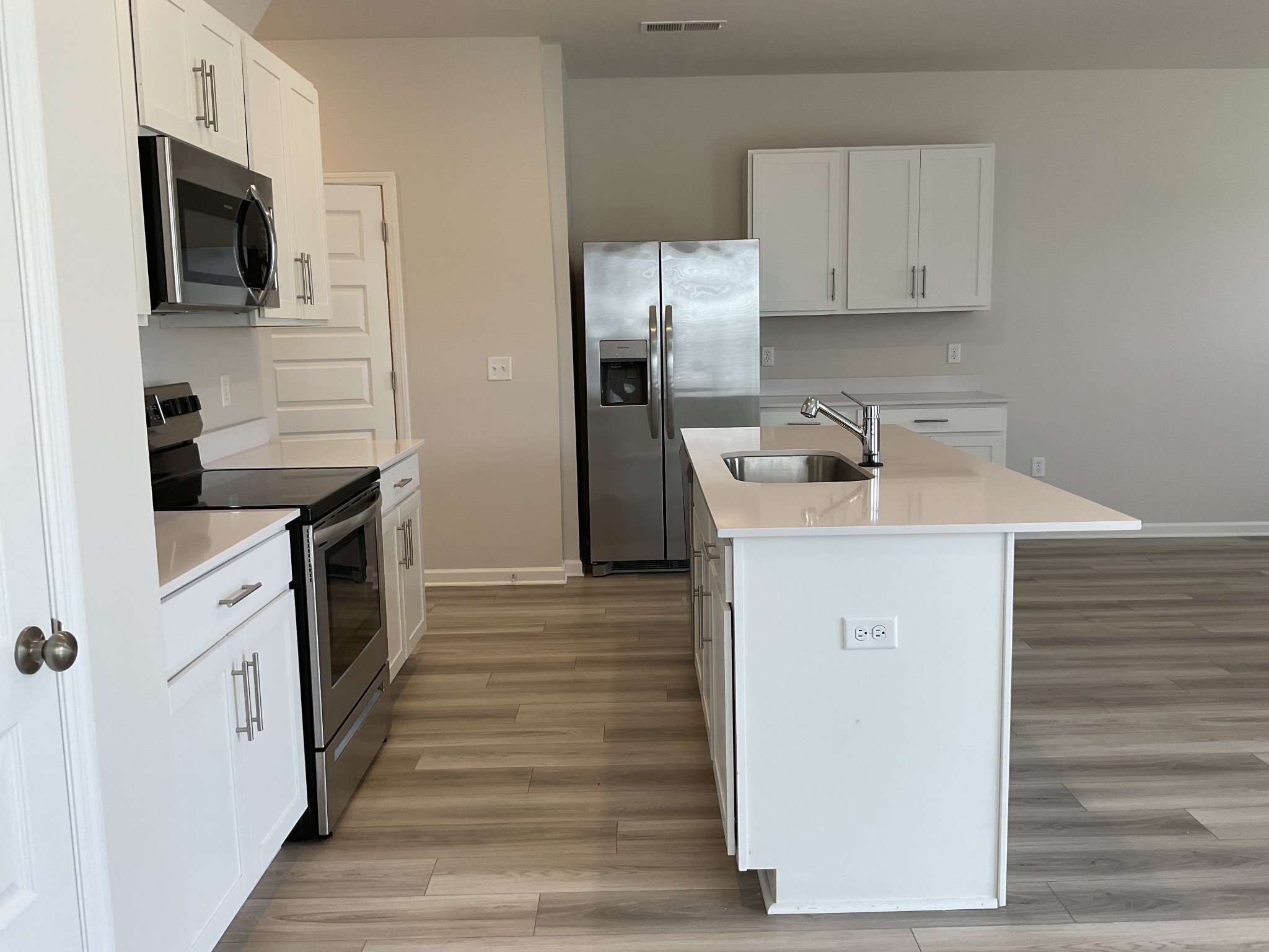 1056 Legacy Court Smyrna, TN 37167 - Photo 6 of 16 a kitchen with stainless steel appliances granite countertop a sink stove and refrigerator