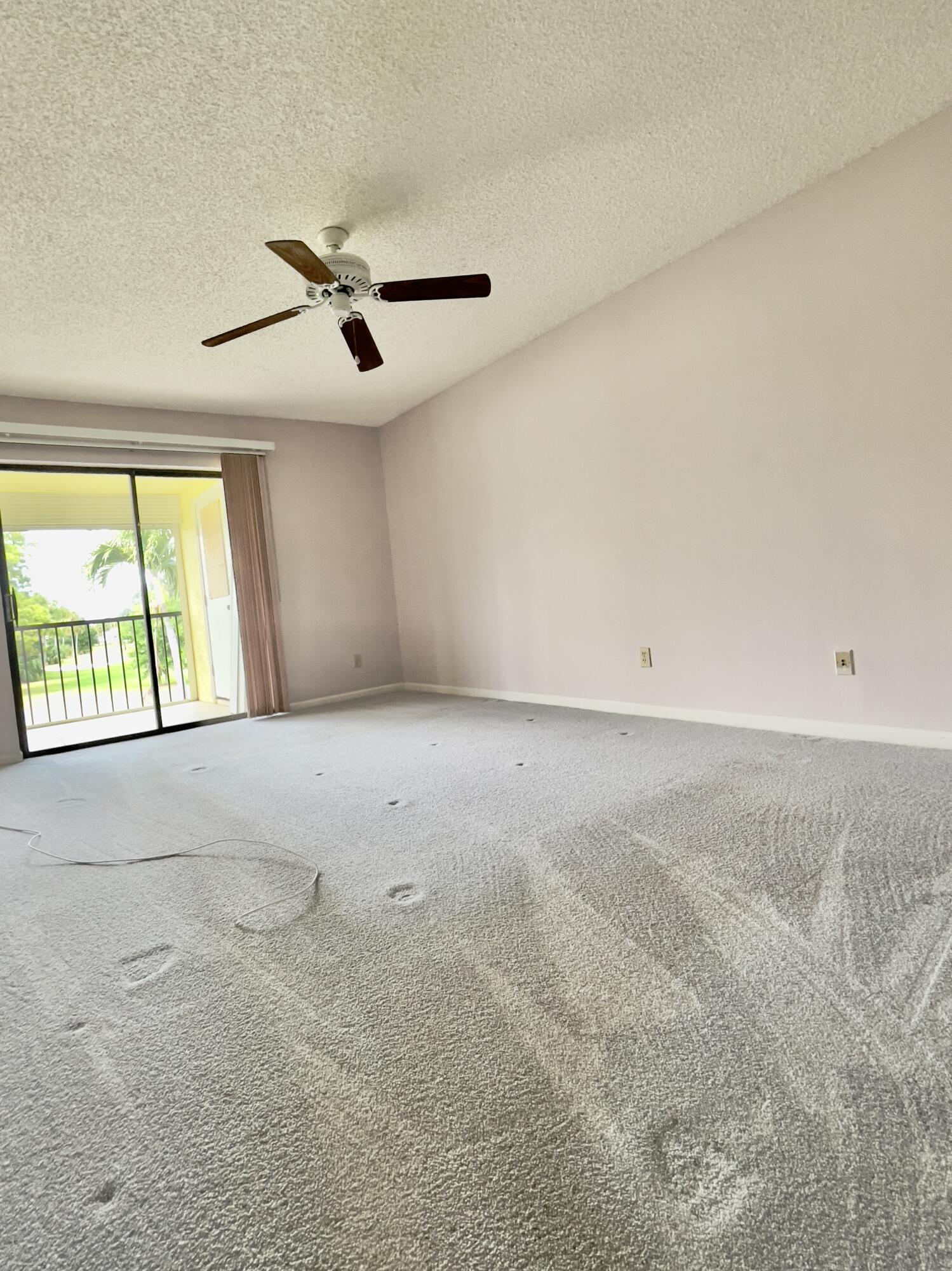 1002 Keystone Drive, Unit B Jupiter, FL 33458 - Photo 16 of 28 Master bedroom with newer carpeting