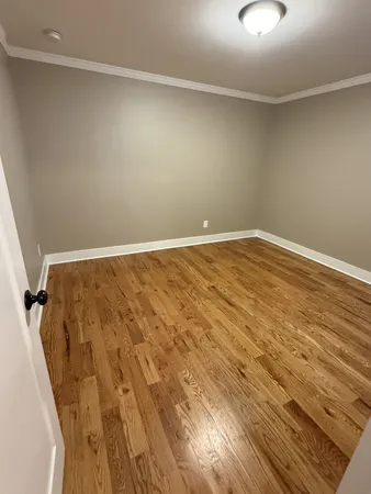 an empty room with wooden floor