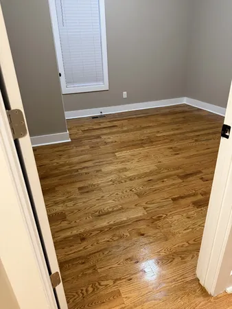 a view of room with wooden floor