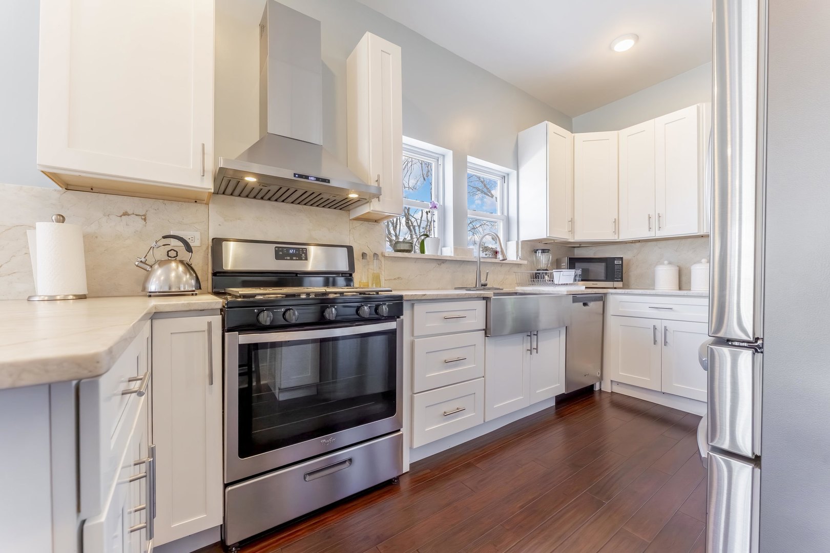 7731 45th Place Lyons, IL 60534 - Photo 6 of 21 a kitchen with stainless steel appliances a white stove top oven and sink