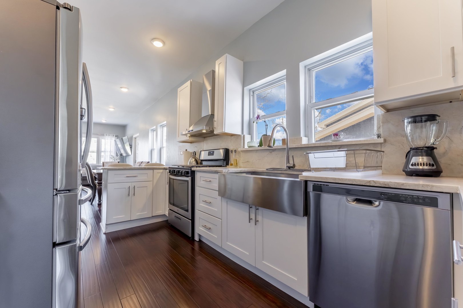 7731 45th Place Lyons, IL 60534 - Photo 7 of 21 a kitchen with white cabinets and white appliances