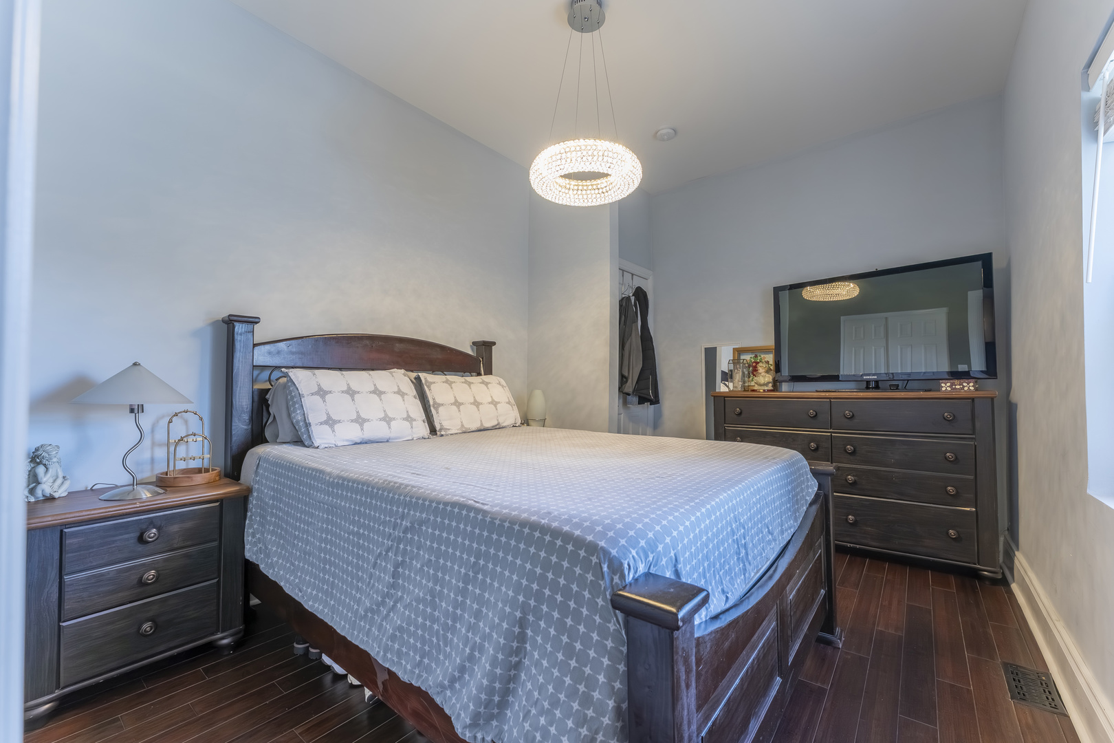 7731 45th Place Lyons, IL 60534 - Photo 9 of 21 a bedroom with a bed and a flat screen tv