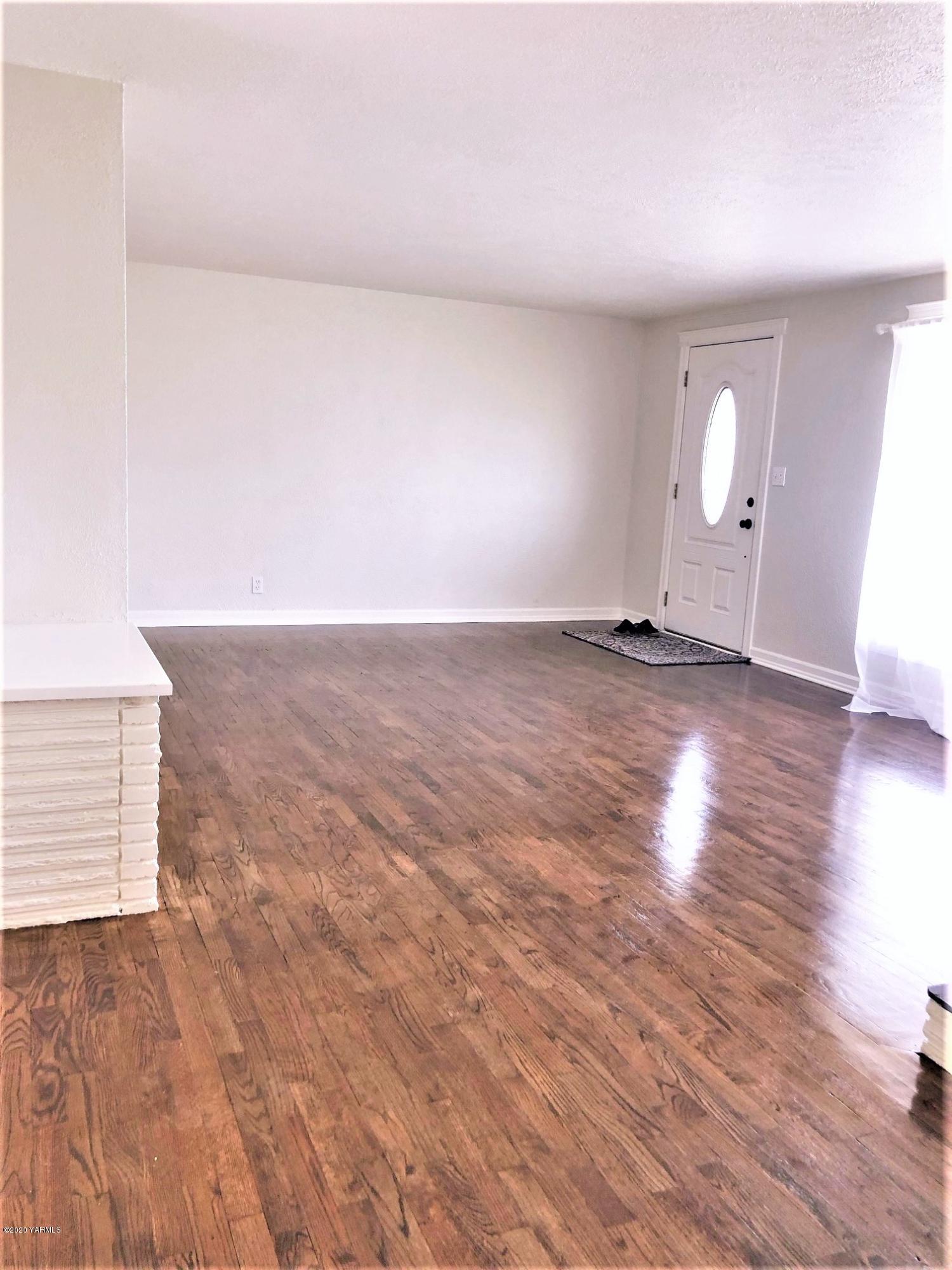 705 West Concord Avenue Grandview, WA 98930 - Photo 2 of 20 a view of an empty room and wooden floor