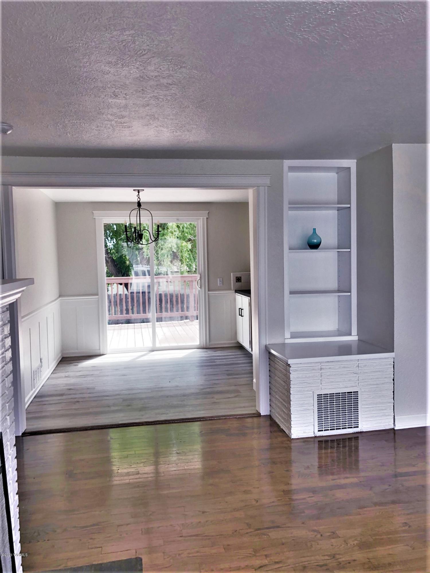 705 West Concord Avenue Grandview, WA 98930 - Photo 4 of 20 a view of water heater room with wooden floor
