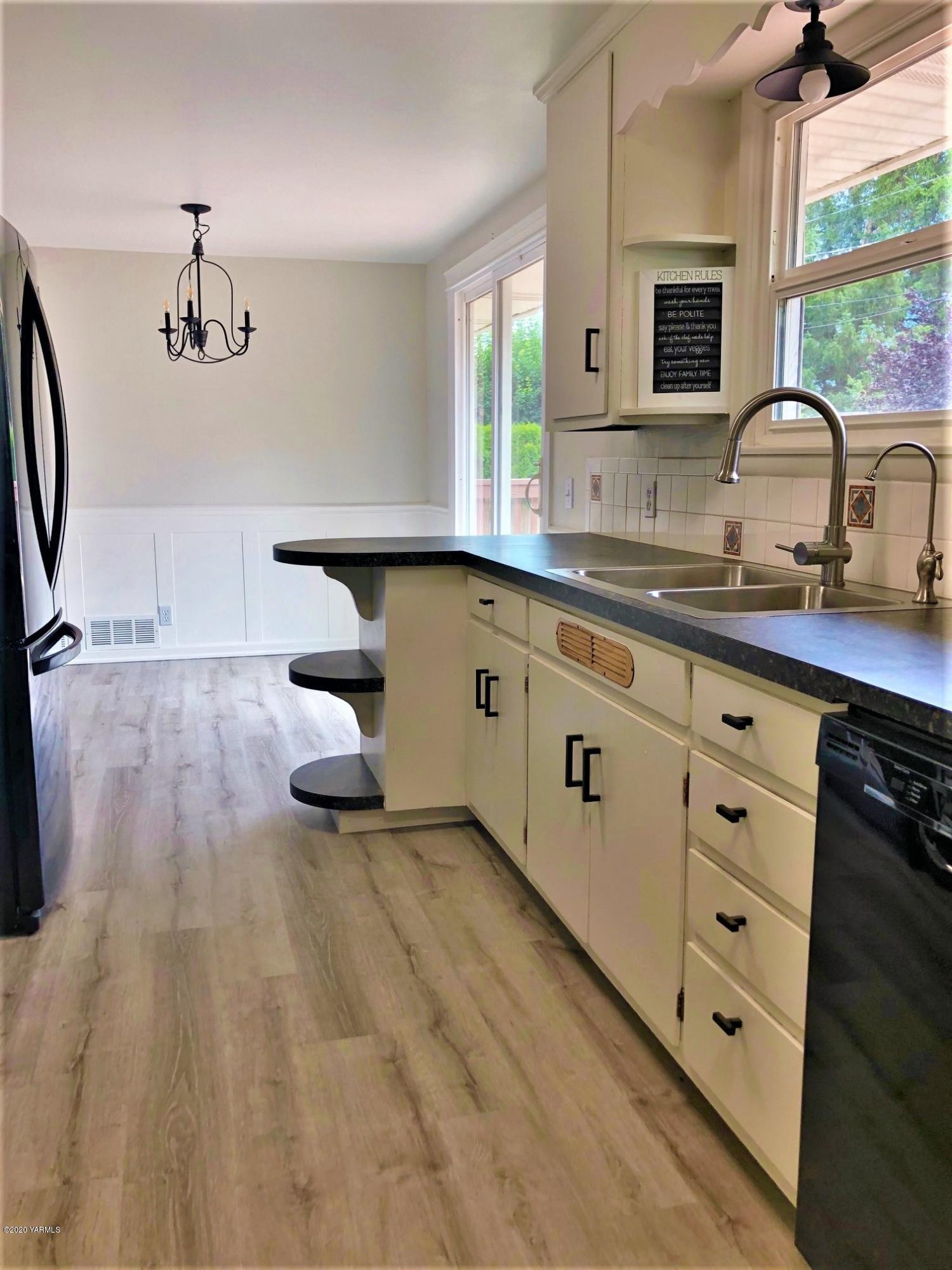 705 West Concord Avenue Grandview, WA 98930 - Photo 5 of 20 a kitchen with cabinets a sink and appliances
