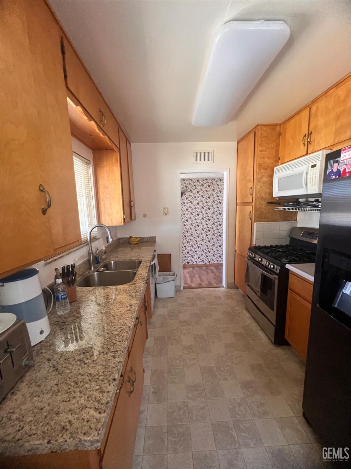 Undisclosed Address Bakersfield, CA 93304 - Photo 4 of 15 a kitchen with stainless steel appliances granite countertop a sink stove and refrigerator