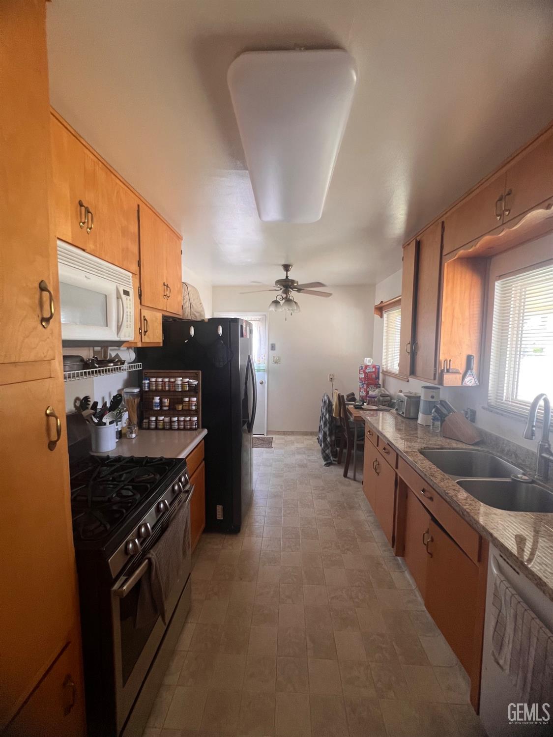 Undisclosed Address Bakersfield, CA 93304 - Photo 5 of 15 a kitchen with stainless steel appliances granite countertop a stove and a sink