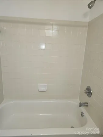 a bedroom with bed and a couch