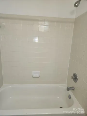 a bedroom with bed and a couch