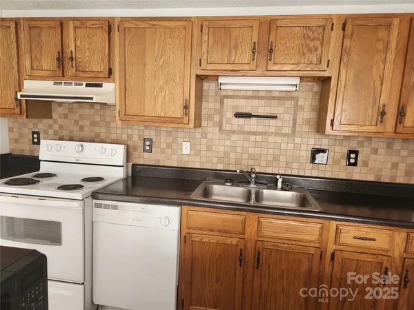 a kitchen with a stove cabinets and a refrigerator