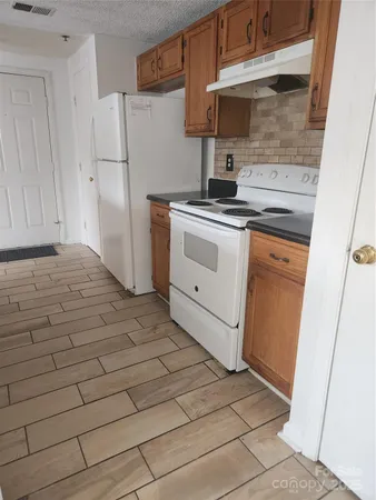 a kitchen with a stove and a refrigerator
