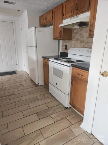 a kitchen with a stove and a refrigerator