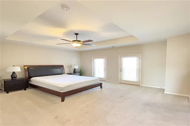 a bedroom with a large bed and a chandelier