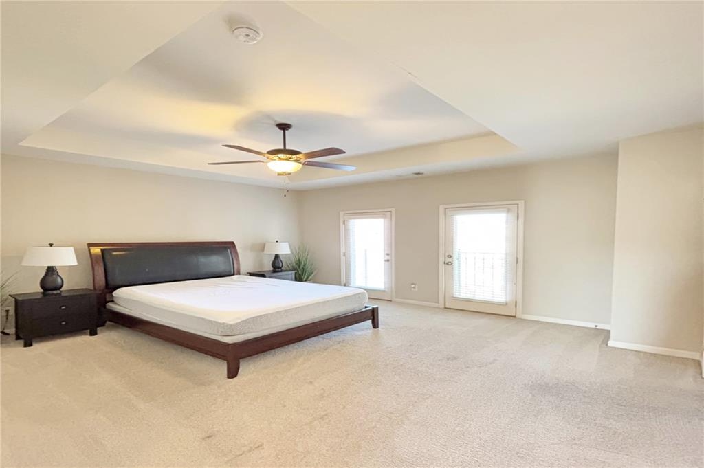 772 Liberty Commons Drive Northwest Atlanta, GA 30314 - Photo 11 of 23 a bedroom with a large bed and a chandelier