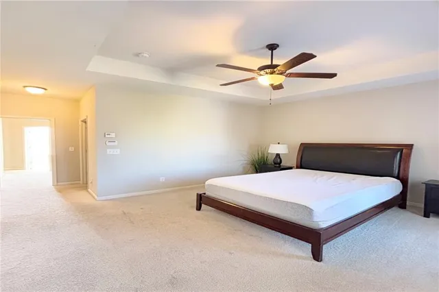 a bedroom with a bed and a ceiling fan