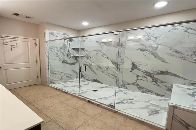 a bathroom with a shower and a sink