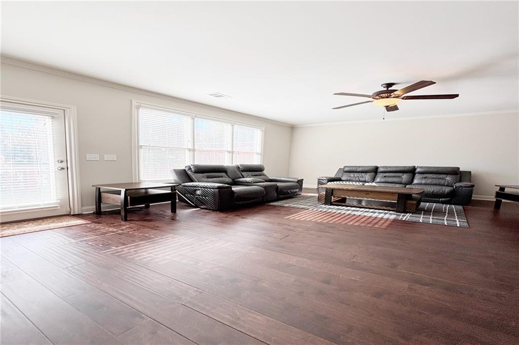 772 Liberty Commons Drive Northwest Atlanta, GA 30314 - Photo 4 of 23 a living room with furniture a ceiling fan and a window