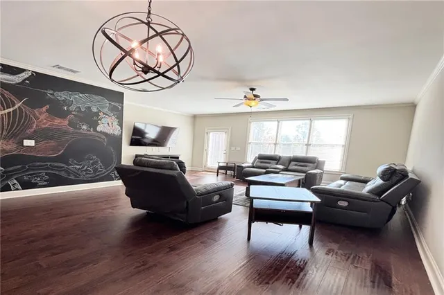 a living room with furniture or couch and a chandelier