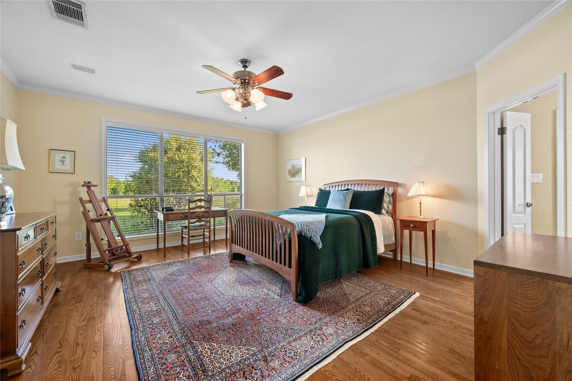 266 Courtnee's Way Georgetown, TX 78626 - Photo 17 of 40 Wake up to stunning views in this Primary suite featuring expansive windows, wood flooring, and high ceiling.