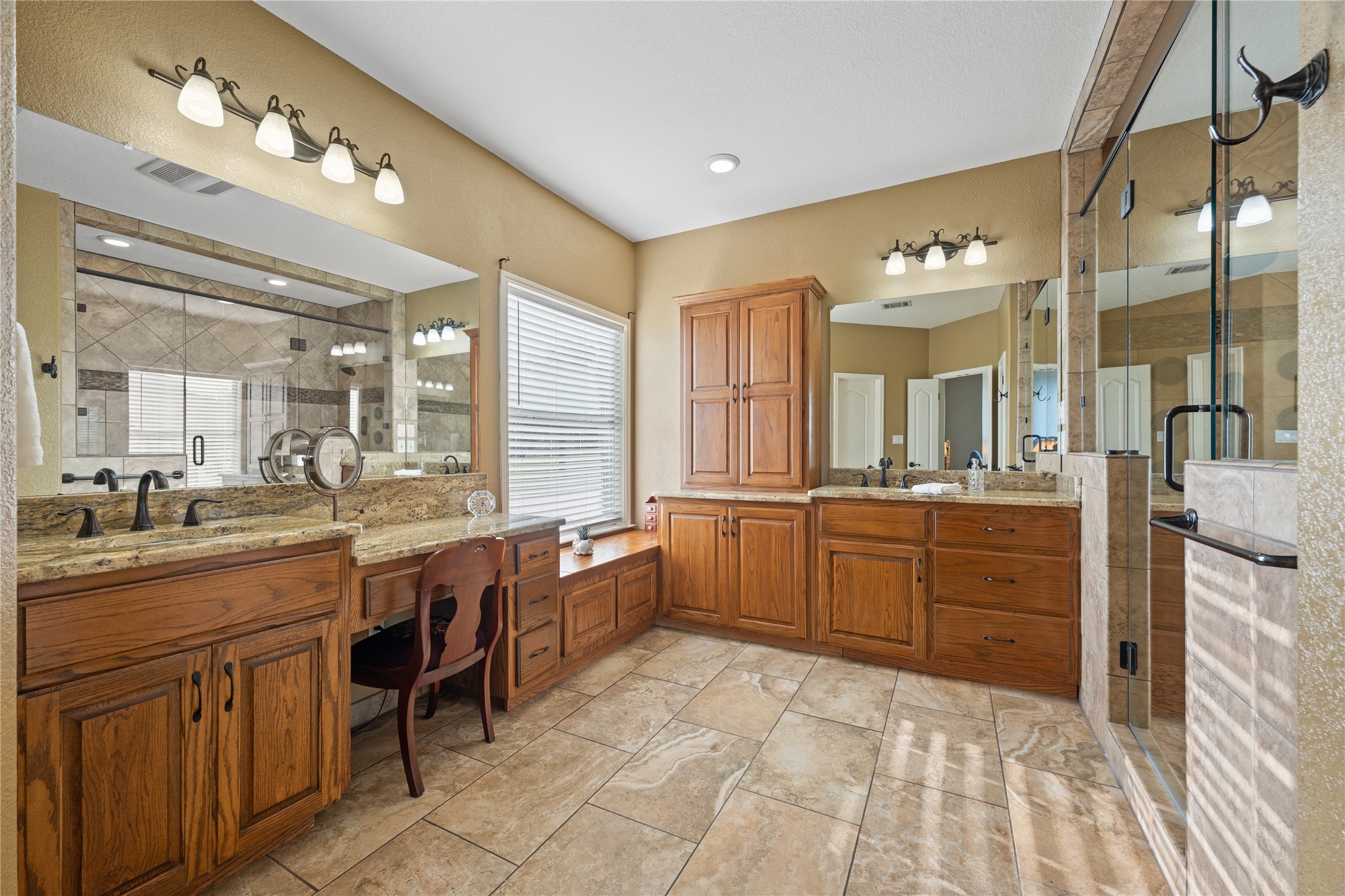 266 Courtnee's Way Georgetown, TX 78626 - Photo 19 of 40 Expansive bathroom featuring custom vanities with granite countertops, and bronze-finish fixtures