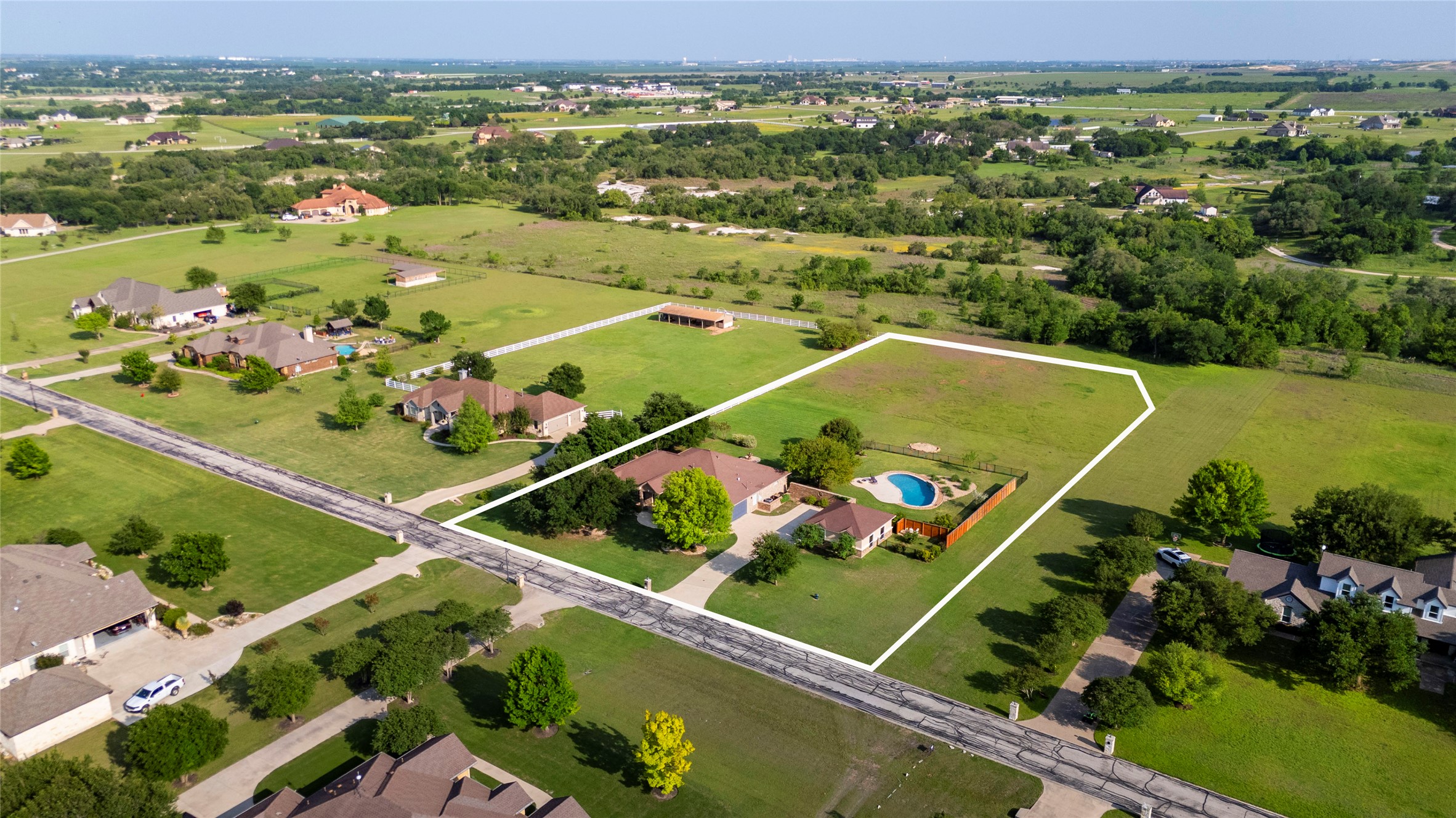 266 Courtnee's Way Georgetown, TX 78626 - Photo 2 of 40 Expansive 2 acre property featuring a single-story home, a private swimming pool with 2 car attached garage and an oversized 2 car detached garage.