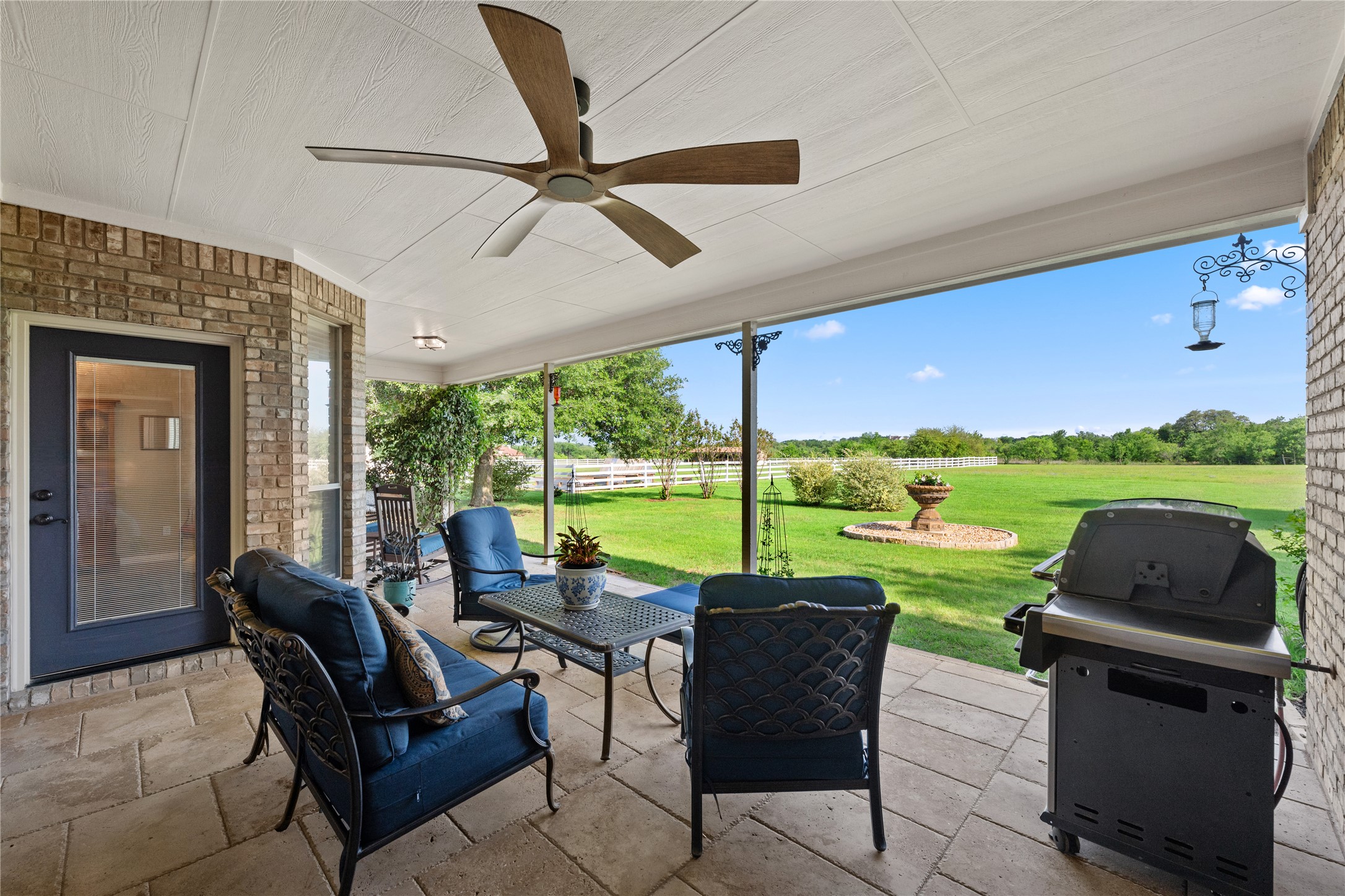 266 Courtnee's Way Georgetown, TX 78626 - Photo 25 of 40 Covered outdoor patio featuring brick exterior, travertine tile flooring, and a beautiful view