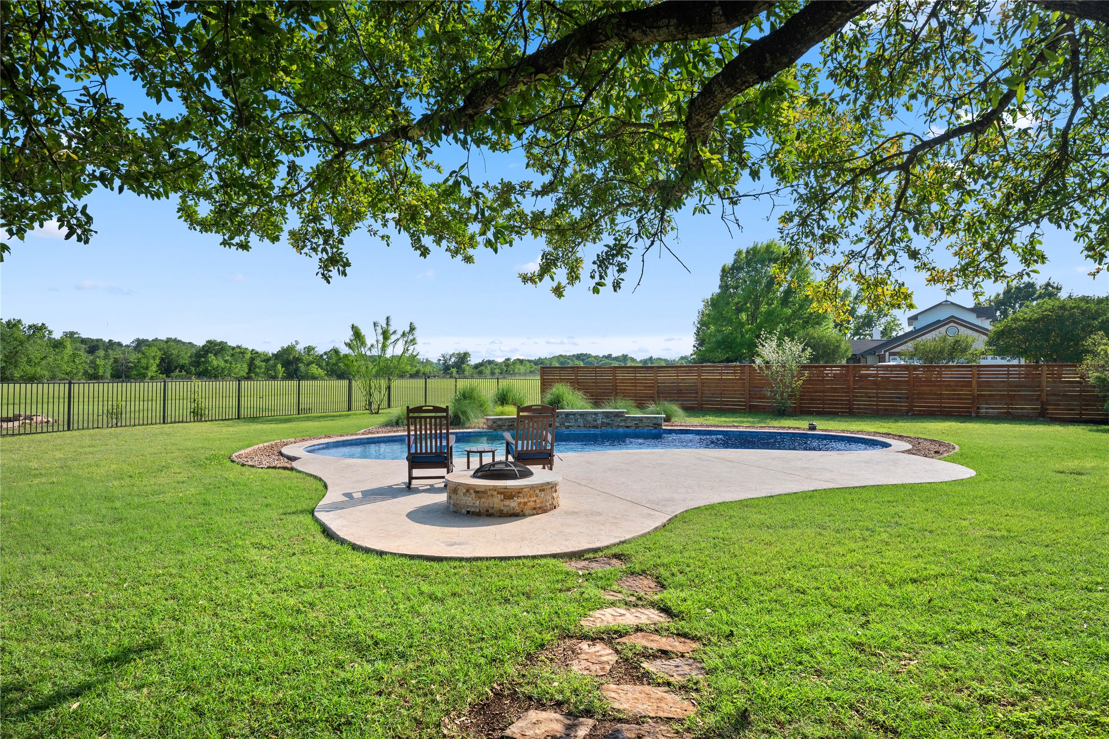266 Courtnee's Way Georgetown, TX 78626 - Photo 29 of 40 Saltwater swimming pool with waterfall, in-floor pool cleaner and stone fire pit.