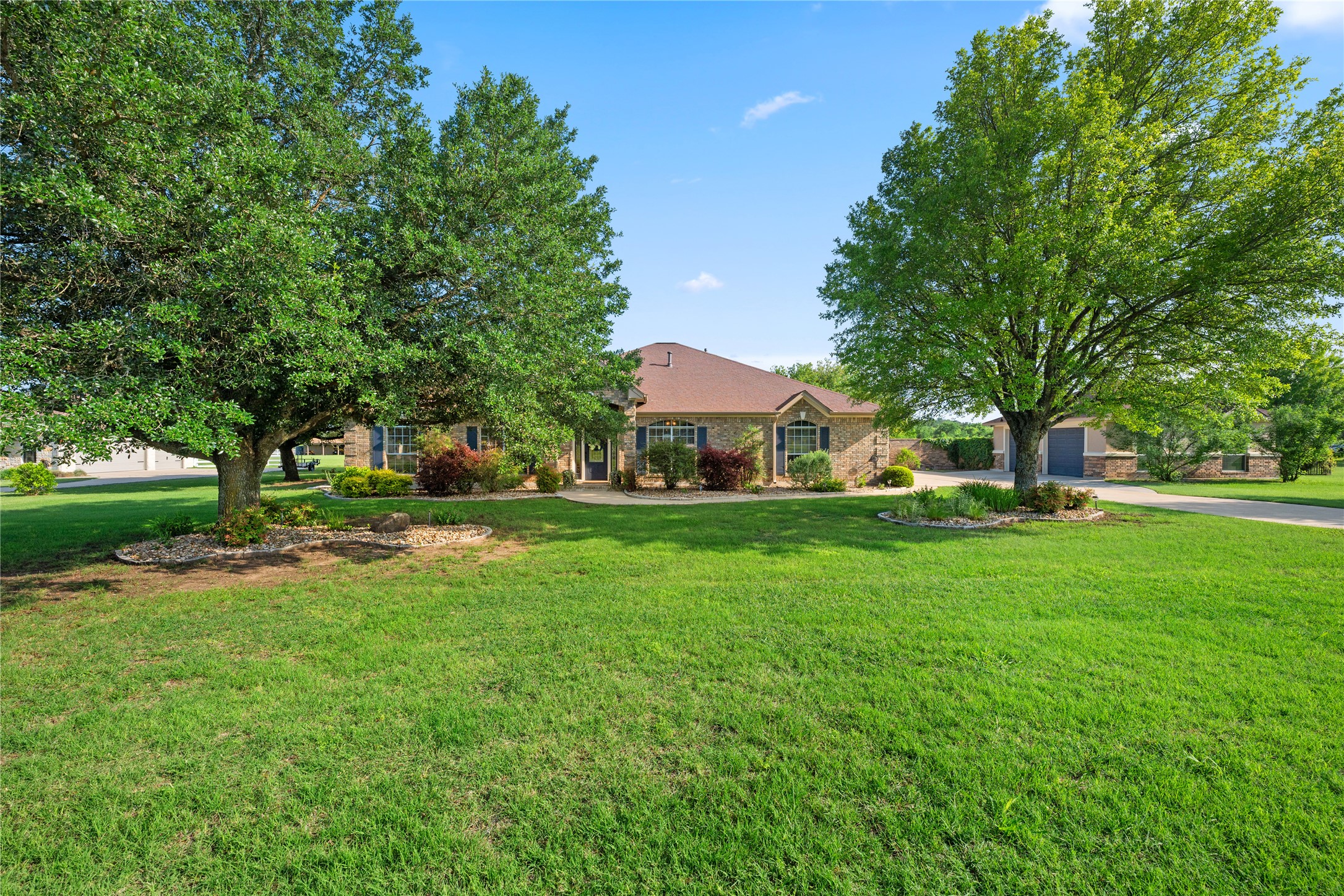 266 Courtnee's Way Georgetown, TX 78626 - Photo 4 of 40 Brick exterior, expansive front lawn with mature shade trees sitting on 2 acres.